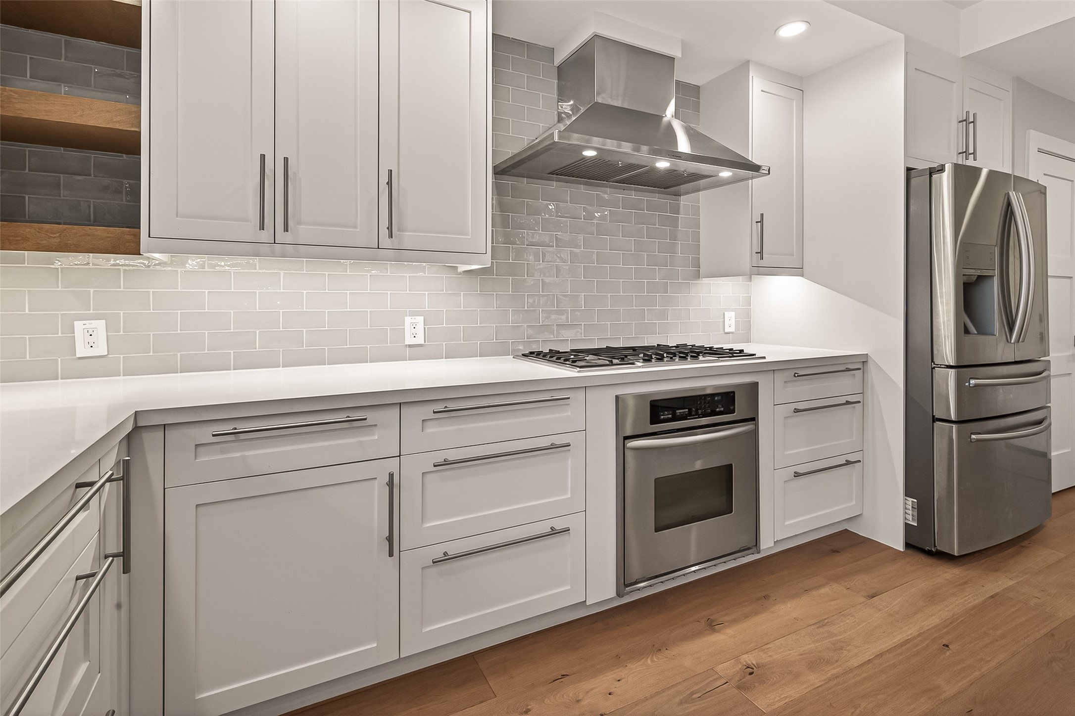 5310 Spellman Road Houston, TX 77096 - Photo 11 of 48 a kitchen with stainless steel appliances white cabinets and a wooden floors