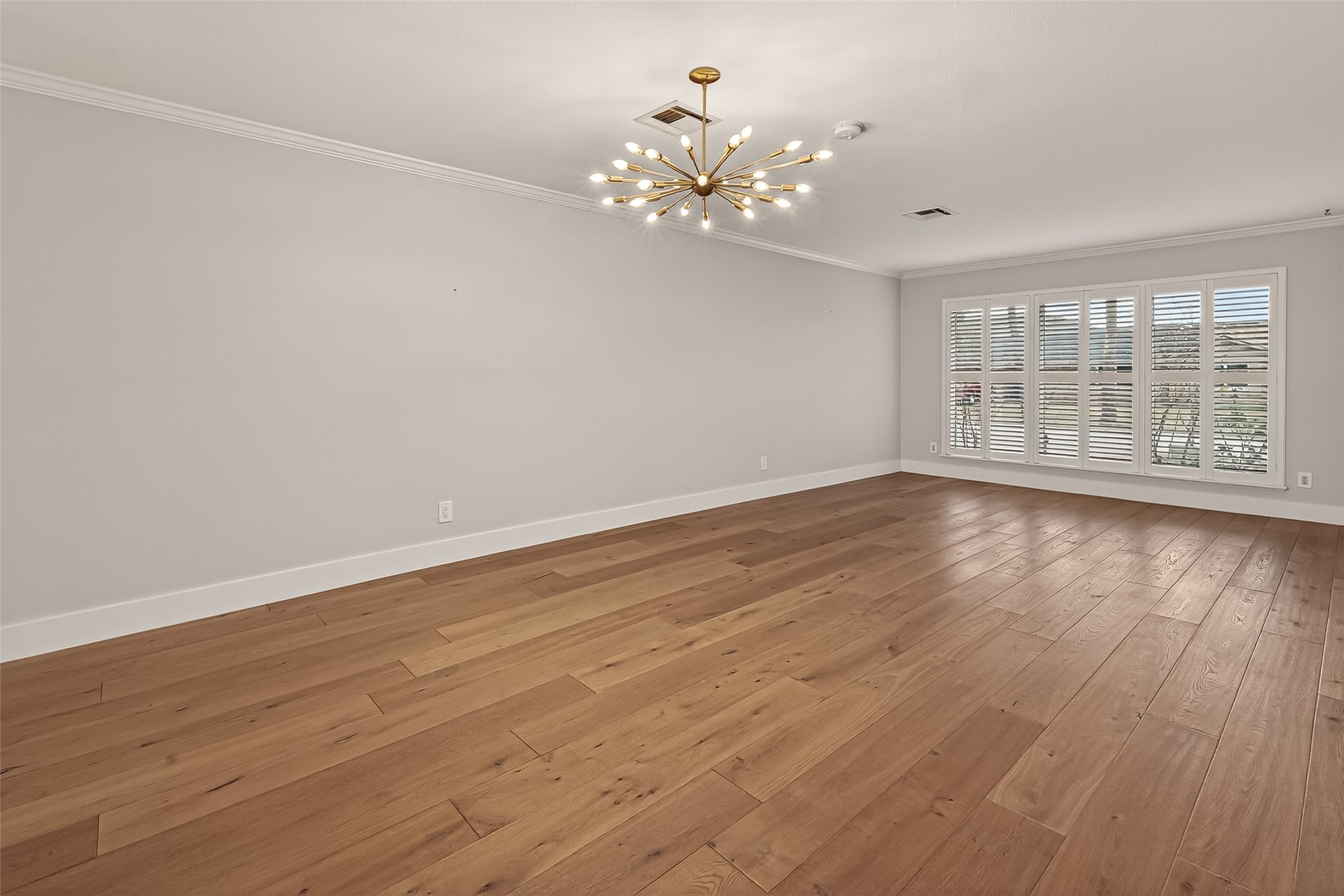 5310 Spellman Road Houston, TX 77096 - Photo 13 of 48 a view of an empty room with wooden floor and a window