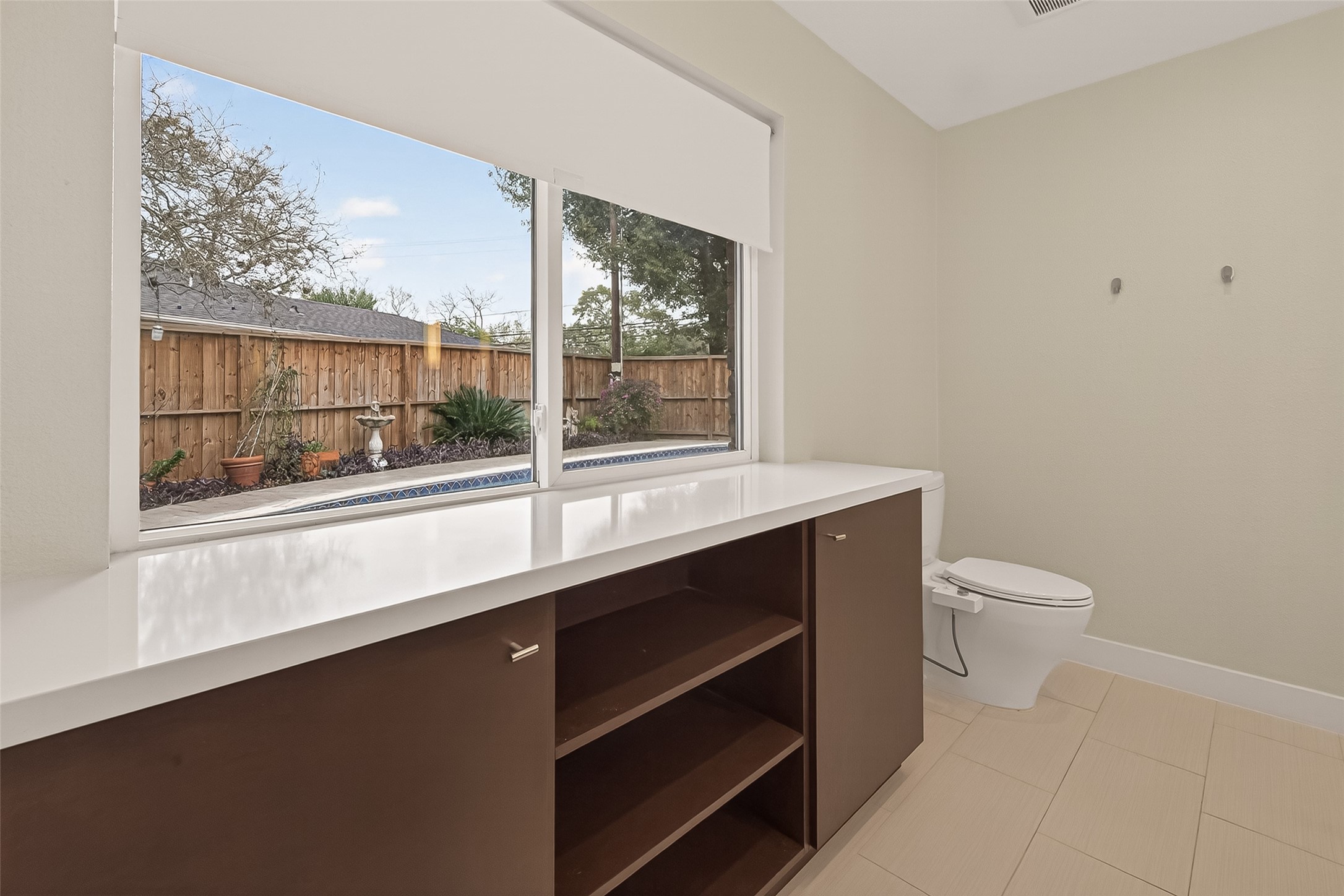 5310 Spellman Road Houston, TX 77096 - Photo 27 of 48 a bathroom with a toilet a sink and a large window
