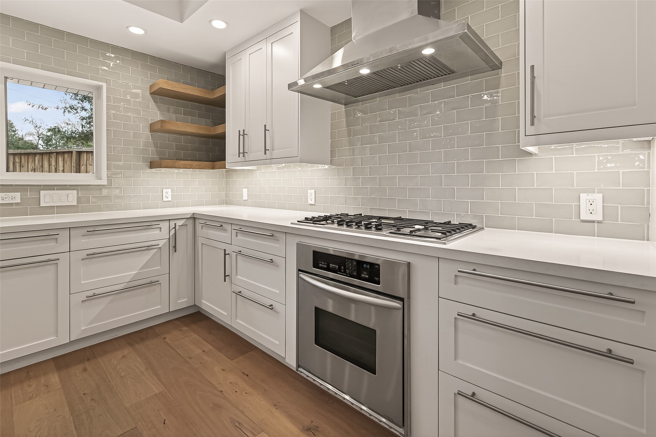 5310 Spellman Road Houston, TX 77096 - Photo 7 of 48 a kitchen with white cabinets stainless steel appliances and sink