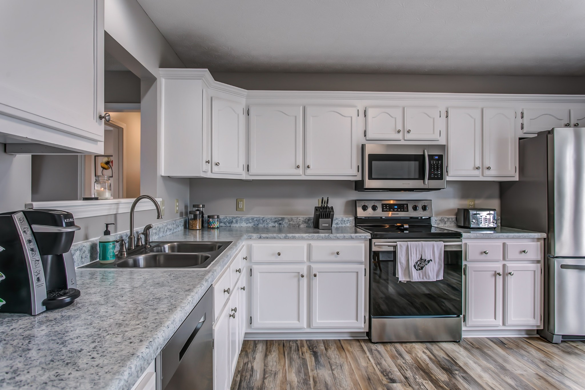332 Bandera Lane Springfield, TN 37172 - Photo 9 of 22 a kitchen with stainless steel appliances granite countertop a stove a sink and a microwave
