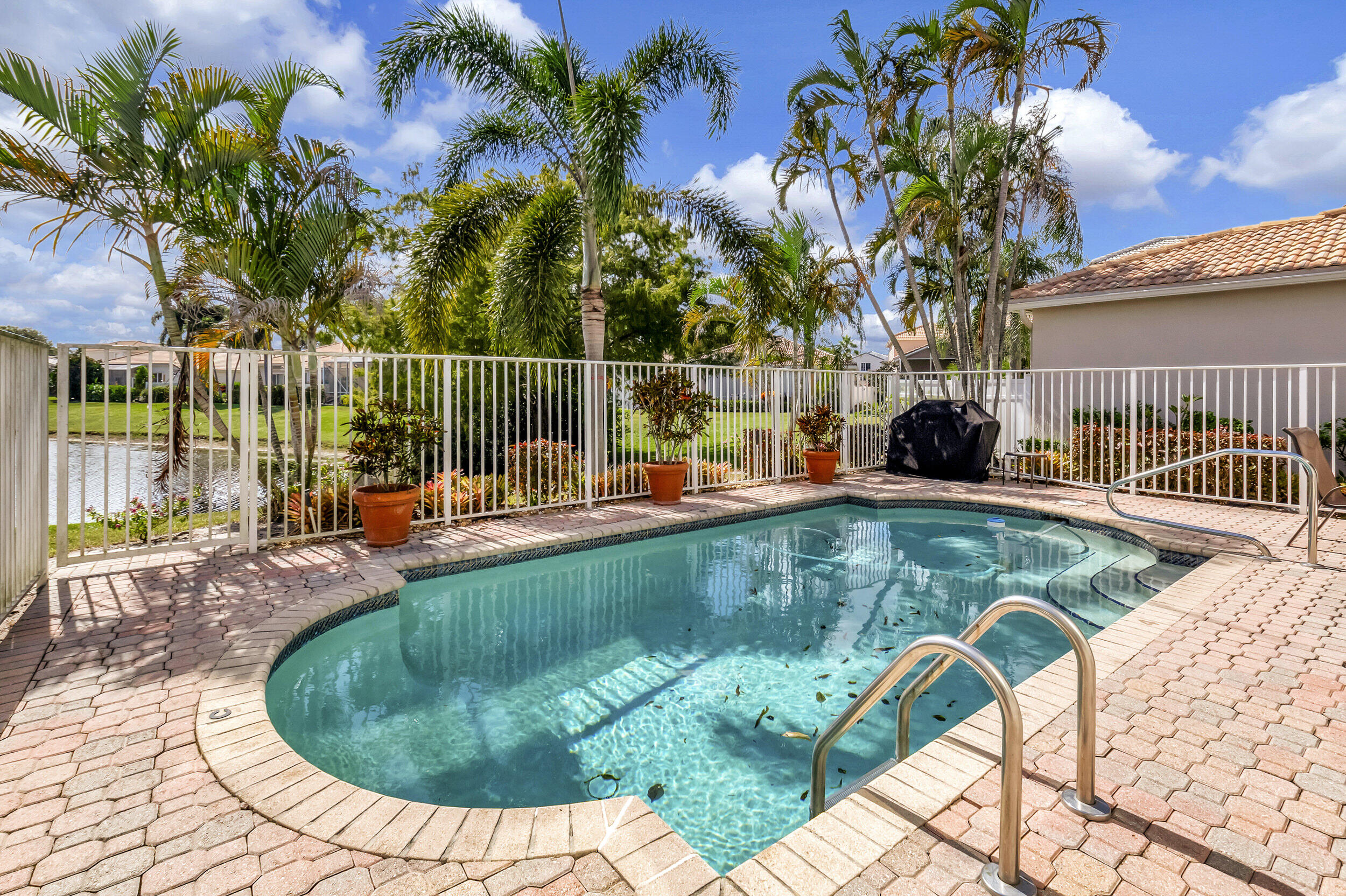 6510 Colomera Drive Boca Raton, FL 33433 - Photo 54 of 63 a view of a swimming pool with a lounge chairs