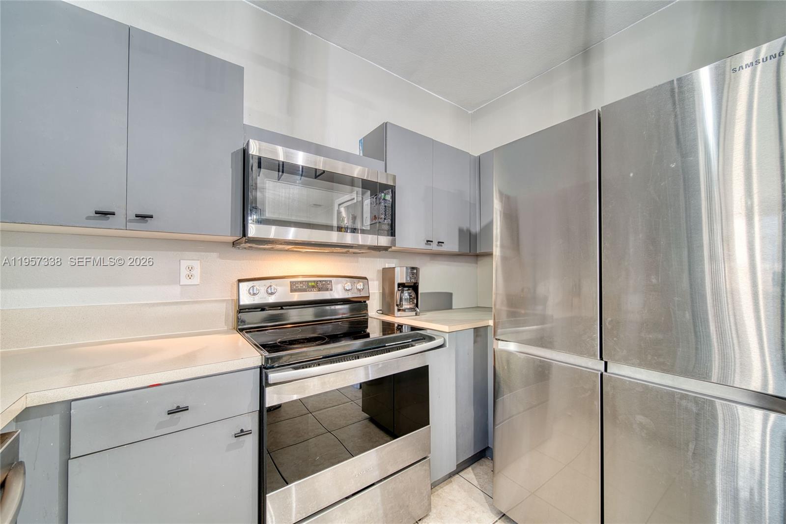 13771 Southwest 274th Terrace Homestead, FL 33032 - Photo 11 of 35 a kitchen with a refrigerator stove and microwave