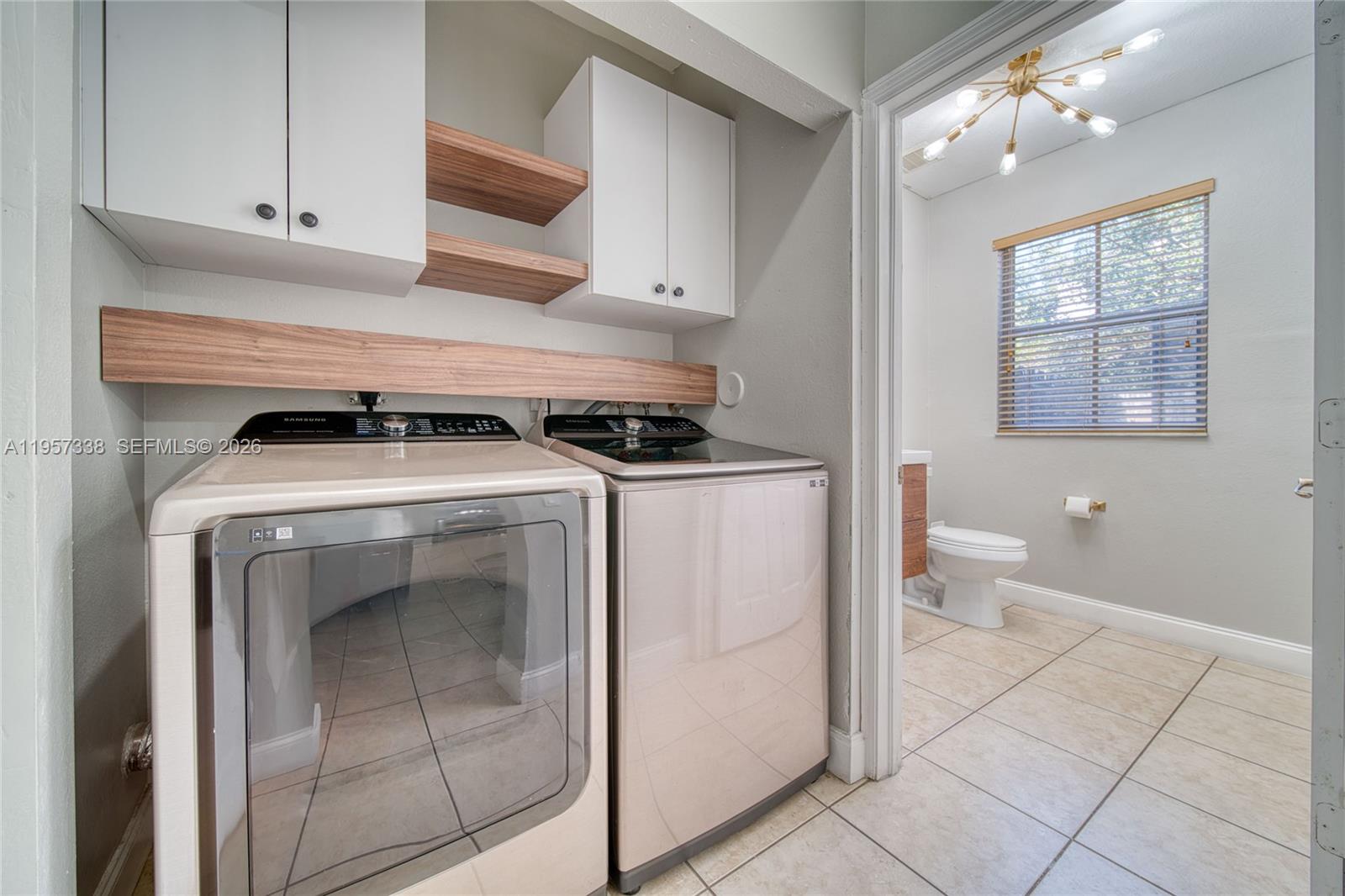 13771 Southwest 274th Terrace Homestead, FL 33032 - Photo 13 of 35 a kitchen with a stove sink and cabinets