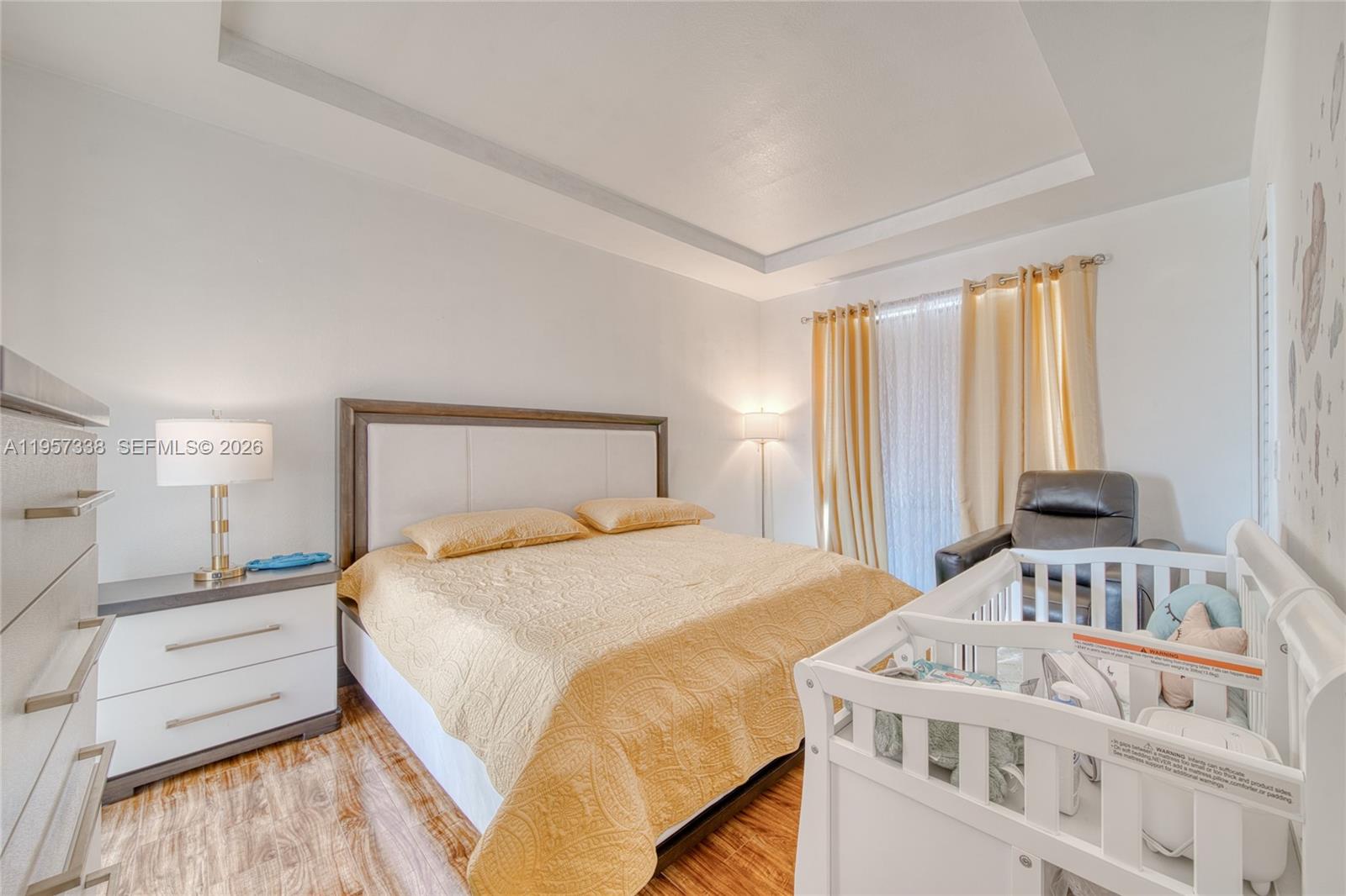 13771 Southwest 274th Terrace Homestead, FL 33032 - Photo 14 of 35 a bedroom with a bed and a large window