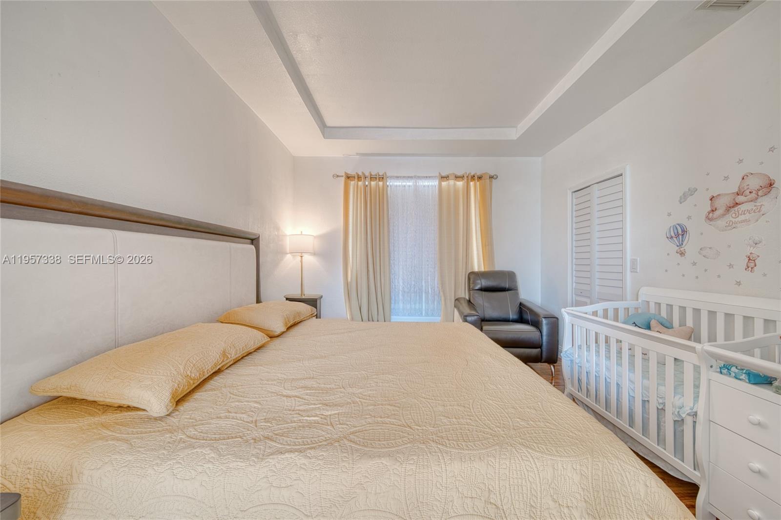 13771 Southwest 274th Terrace Homestead, FL 33032 - Photo 15 of 35 a bedroom with a bed and a large window