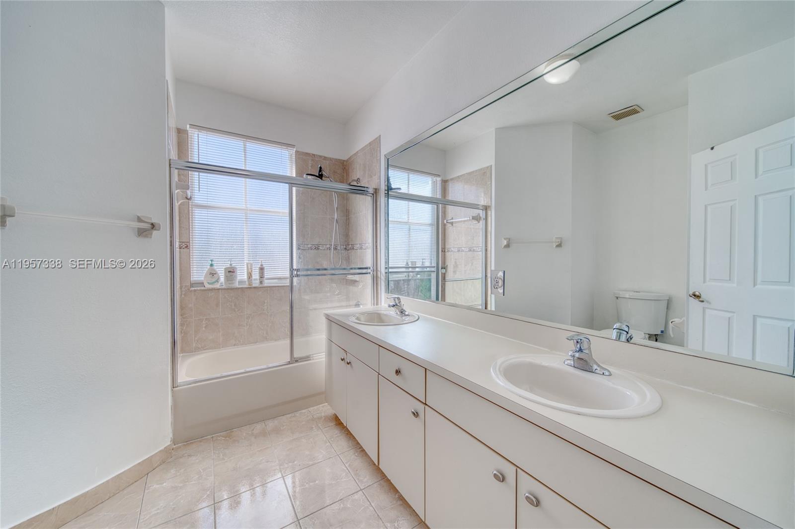13771 Southwest 274th Terrace Homestead, FL 33032 - Photo 17 of 35 a bathroom with a sink double vanity and a mirror