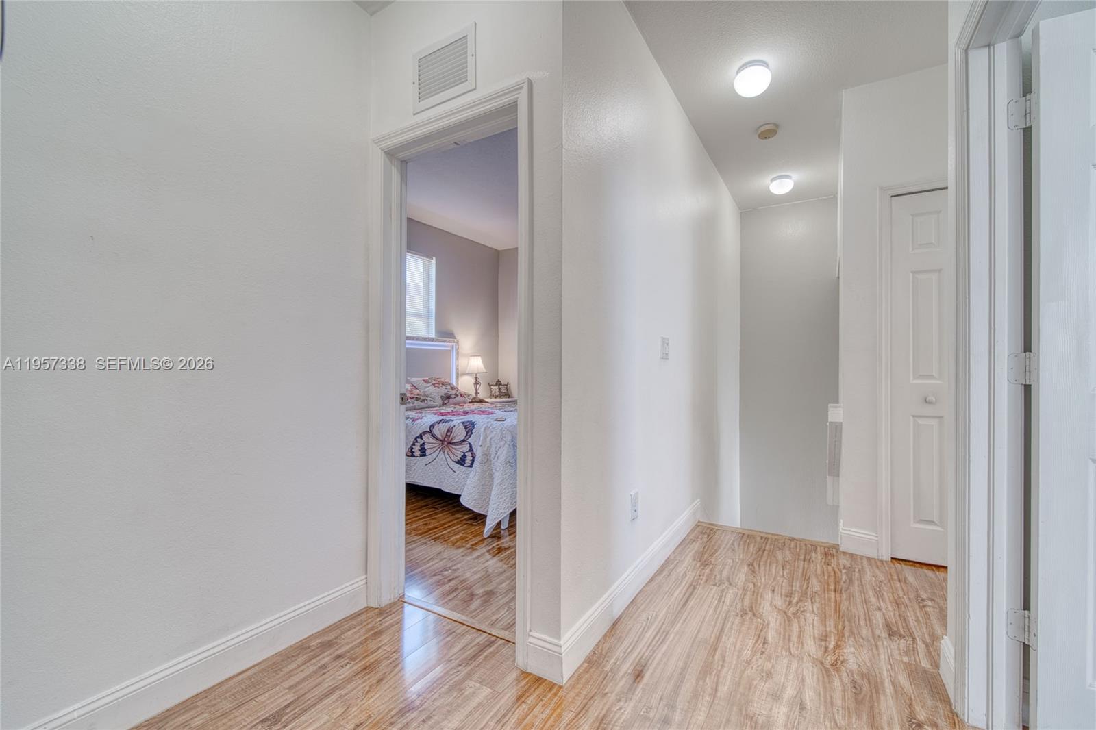 13771 Southwest 274th Terrace Homestead, FL 33032 - Photo 20 of 35 a view of a hallway and wooden floor