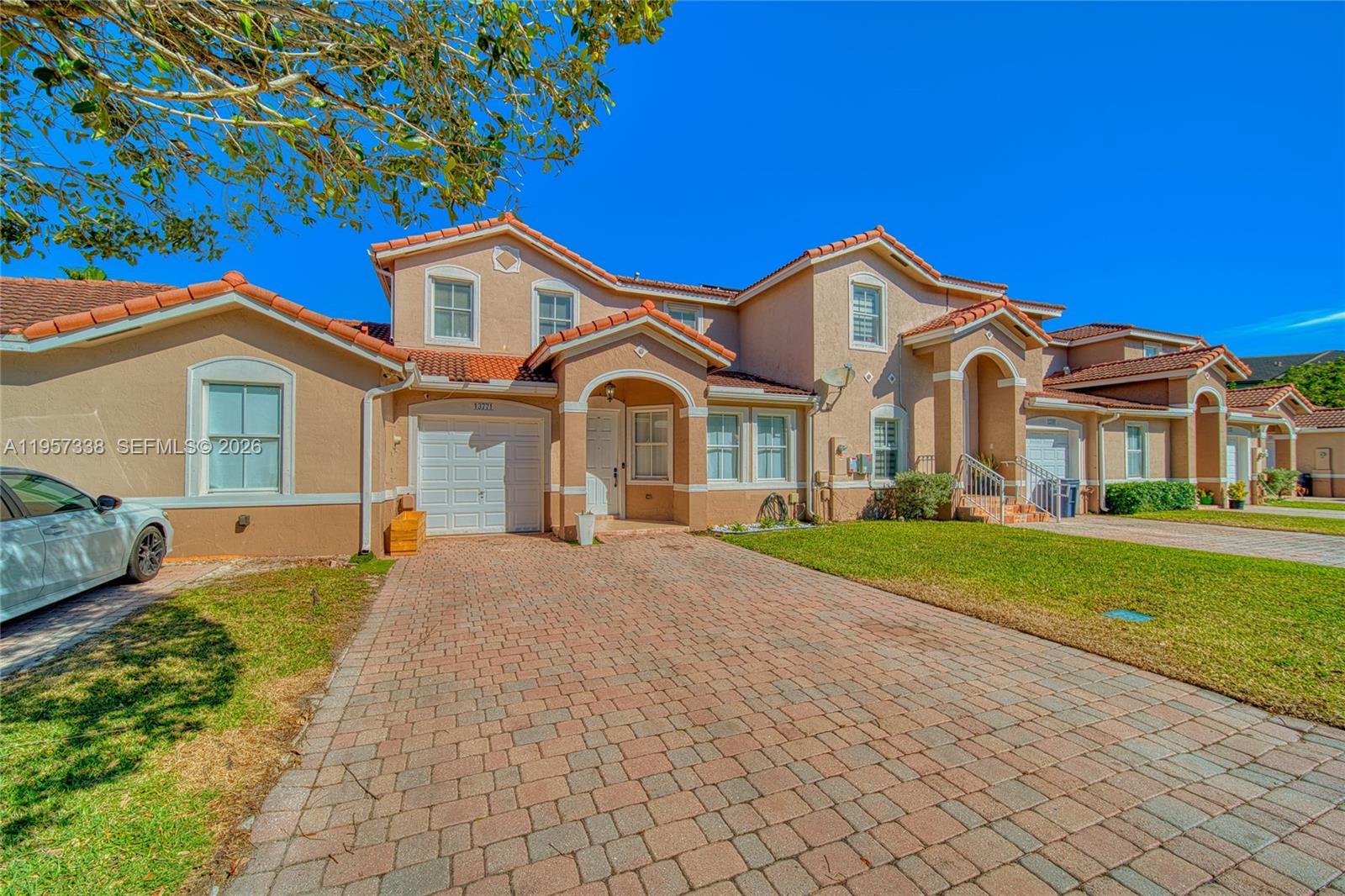 13771 Southwest 274th Terrace Homestead, FL 33032 - Photo 2 of 35 a front view of a house with a garden and yard