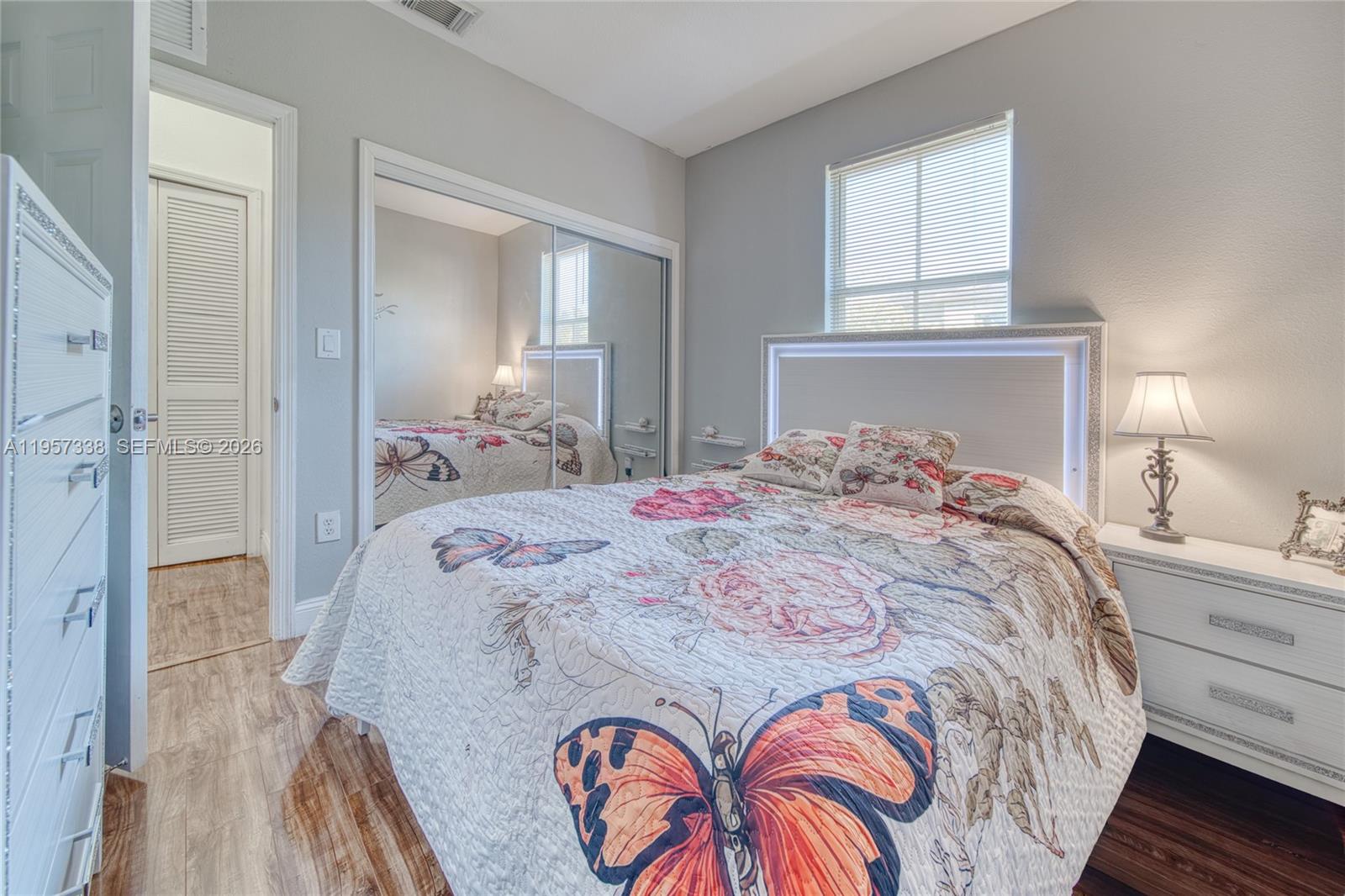 13771 Southwest 274th Terrace Homestead, FL 33032 - Photo 23 of 35 a bedroom with a bed and a lamp