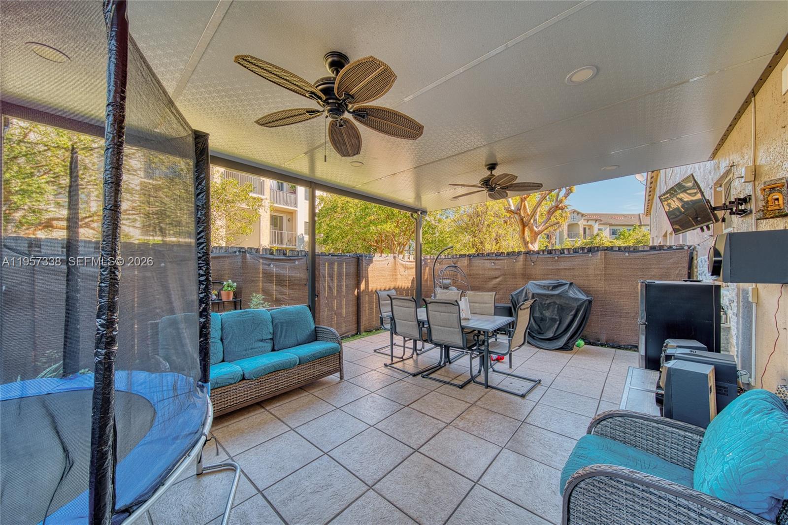 13771 Southwest 274th Terrace Homestead, FL 33032 - Photo 24 of 35 a living room with furniture and a floor to ceiling window