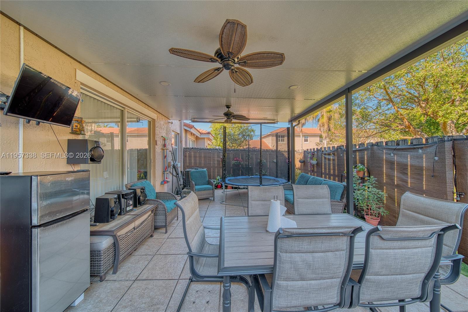 13771 Southwest 274th Terrace Homestead, FL 33032 - Photo 26 of 35 a outdoor space with patio the couches and a dining table with garden view