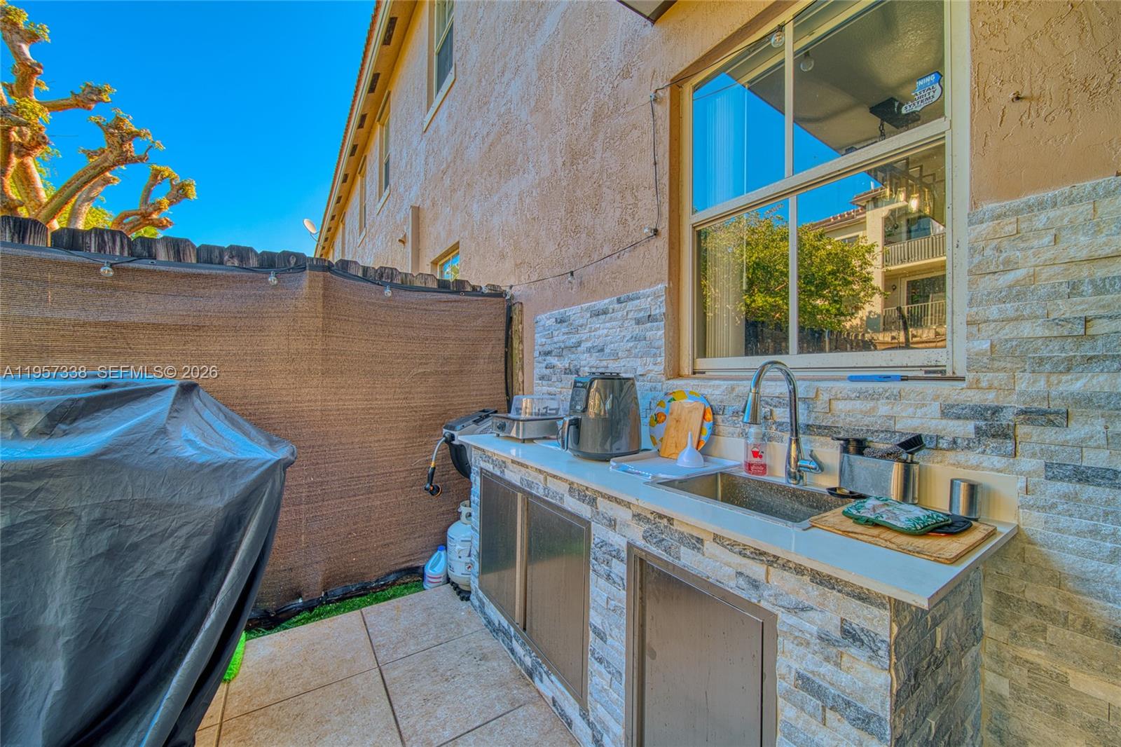 13771 Southwest 274th Terrace Homestead, FL 33032 - Photo 27 of 35 a bathroom with a sink a vanity and a painting on the wall