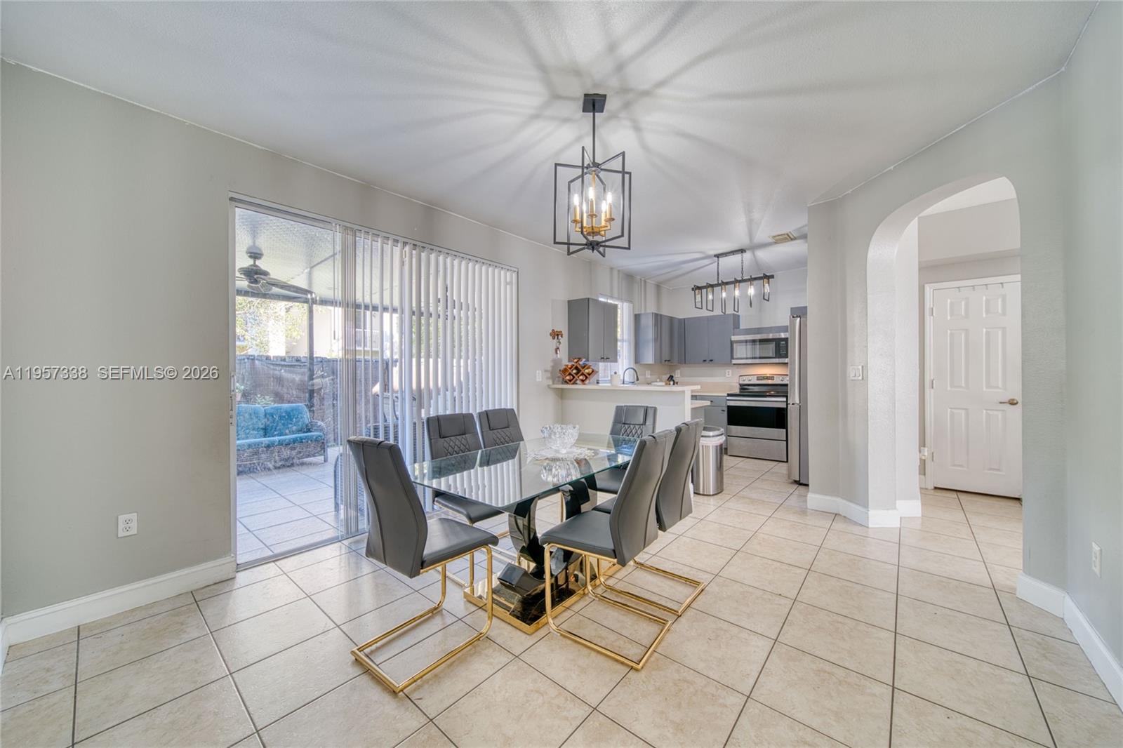 13771 Southwest 274th Terrace Homestead, FL 33032 - Photo 7 of 35 a view of a dining room with furniture and chandelier