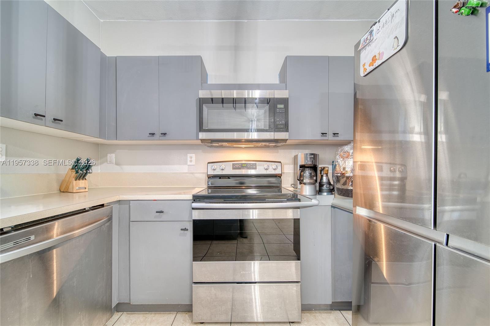 13771 Southwest 274th Terrace Homestead, FL 33032 - Photo 10 of 35 a kitchen with stainless steel appliances granite countertop a stove and a refrigerator
