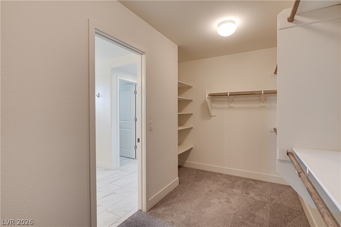 5954 Smith Valley Road Las Vegas, NV 89148 - Photo 17 of 23 Optimal storage awaits with built-in shelving and hanging space within this well-appointed closet.