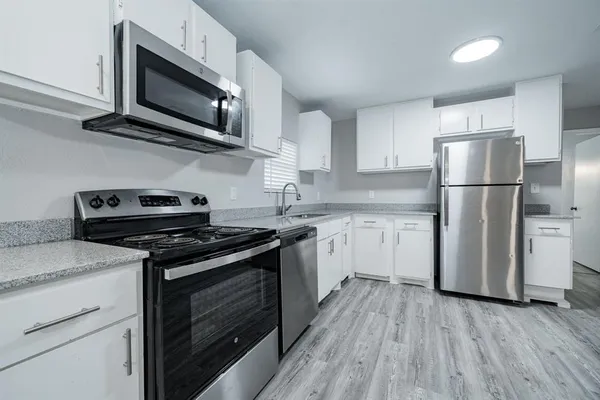 a kitchen with a stove microwave and refrigerator