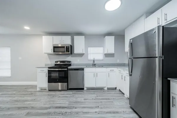 a kitchen with a refrigerator stove and microwave