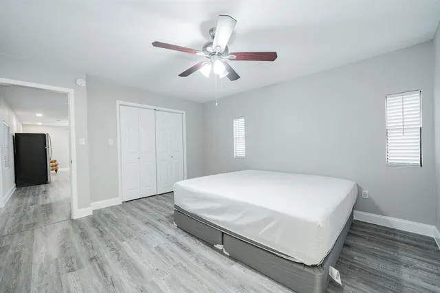 a bedroom with a bed and a ceiling fan