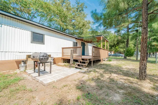 a view of a house with backyard and sitting area