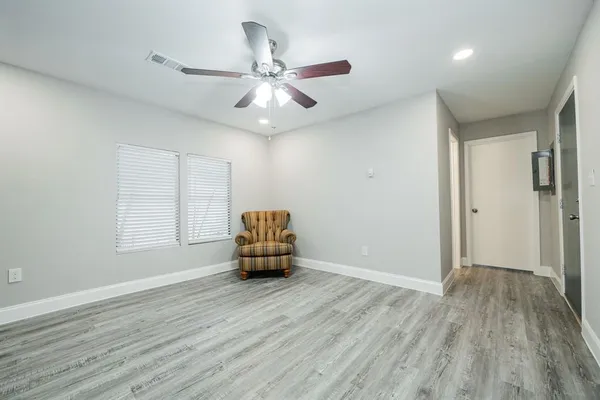 a living room with wooden floor furniture and a window