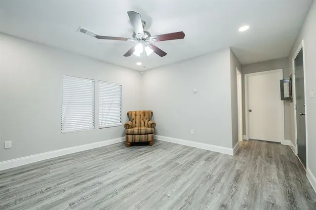 a living room with wooden floor furniture and a window