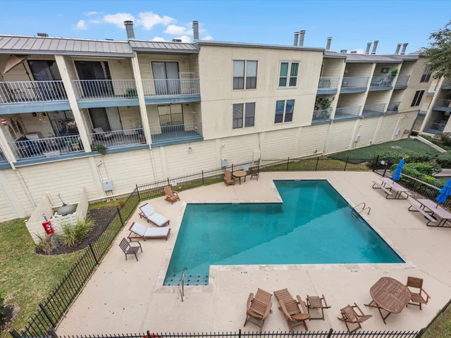 a view of a swimming pool with outdoor seating