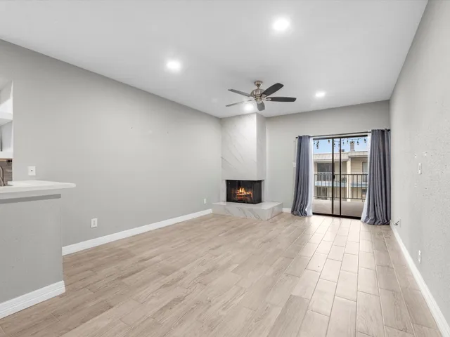 a view of a kitchen with a sink and a refrigerator