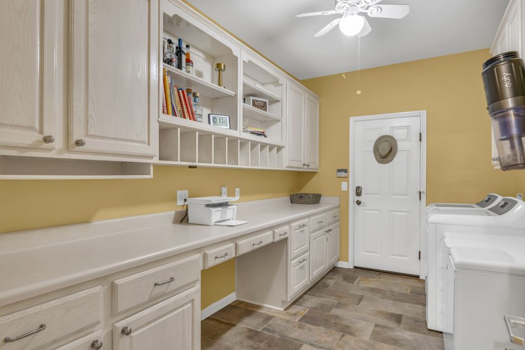 144 Cattle Trail Way Georgetown, TX 78633 - Photo 11 of 37 A well-organized laundry room features extensive built-in cabinetry and durable flooring.