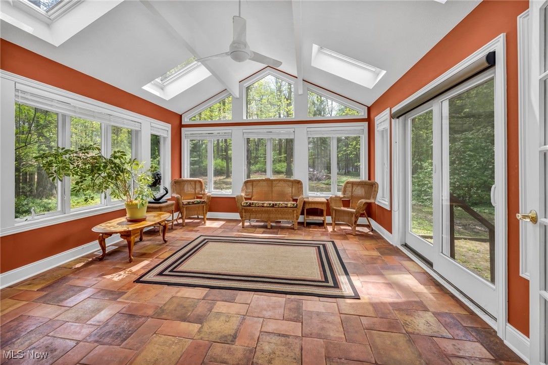 800 Bell Road Chagrin Falls, OH 44022 - Photo 14 of 35 Sunroom / solarium featuring a skylight, vaulted ceiling, baseboards, and french doors