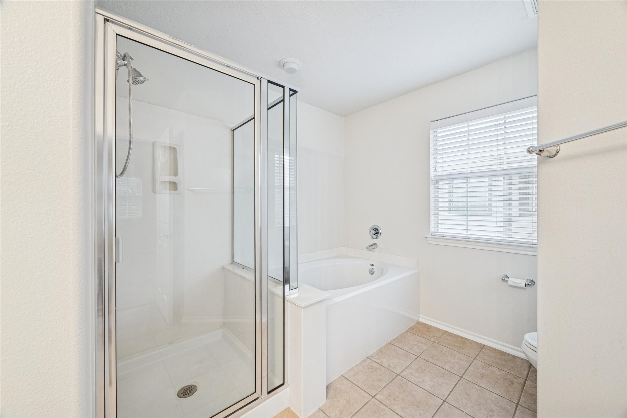 3206 Pearl Bluff Lane Houston, TX 77047 - Photo 13 of 20 a bathroom with a bathtub and a shower