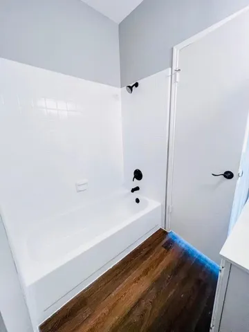 a bathroom with a bathtub and shower