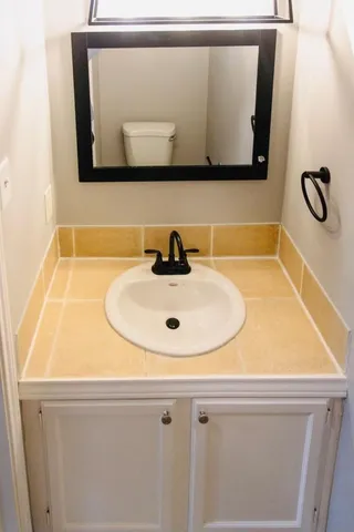 a bathroom with a sink and mirror