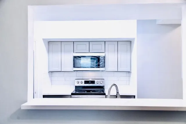 a kitchen with a sink and a microwave