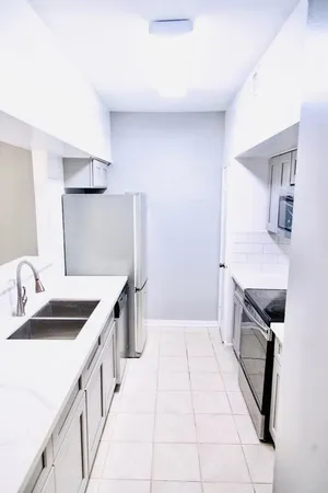 a kitchen with a sink stove and cabinets