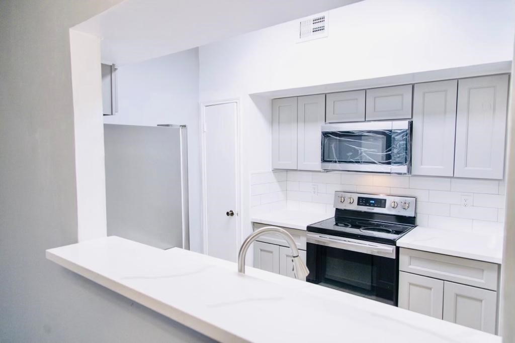 7284 Regency Square Court, Unit 7284 Houston, TX 77036 - Photo 9 of 19 a bedroom with a bed and a flat screen tv