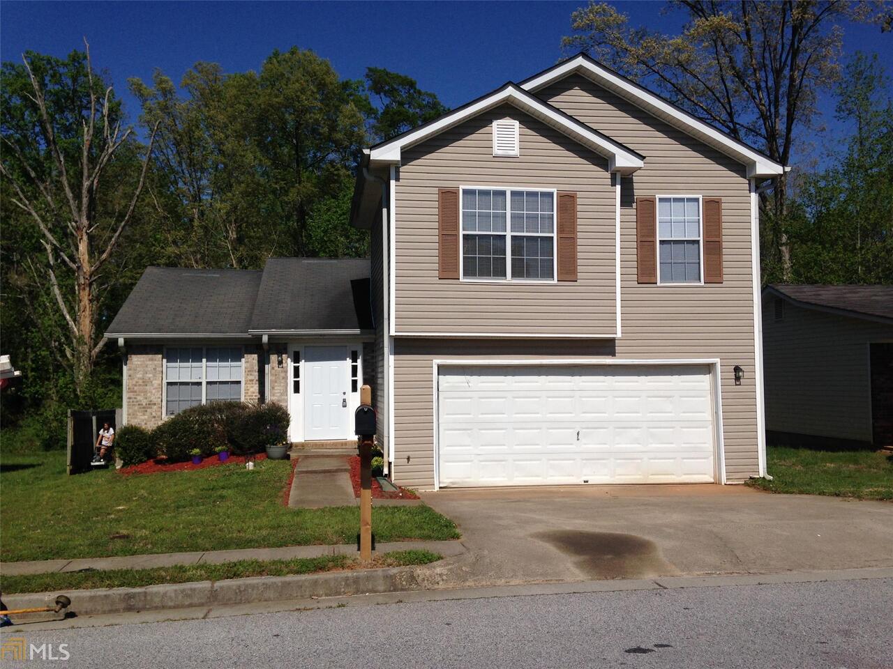3258 Springside Ridge, Unit 7 Decatur, GA 30034 - Photo 1 of 1 a front view of a house with a yard and garage