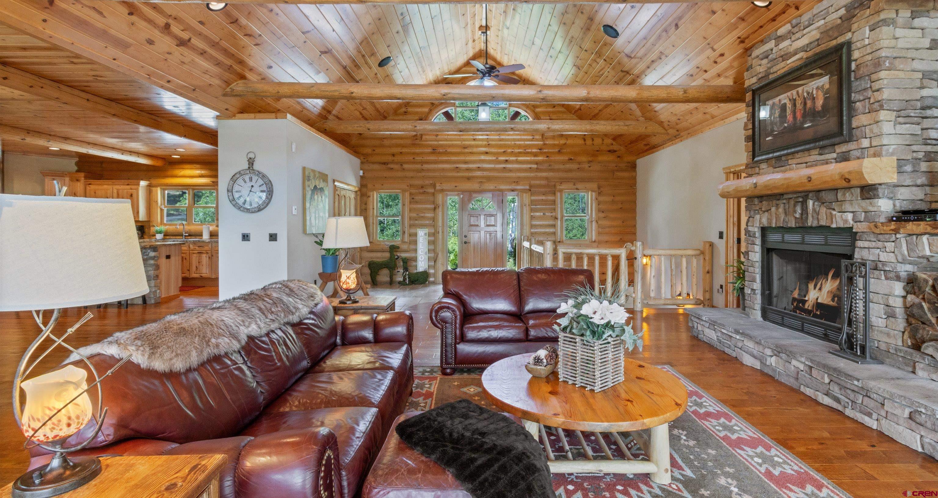 640 Clearview Road Durango, CO 81301 - Photo 12 of 40 a living room with furniture a fireplace and a table