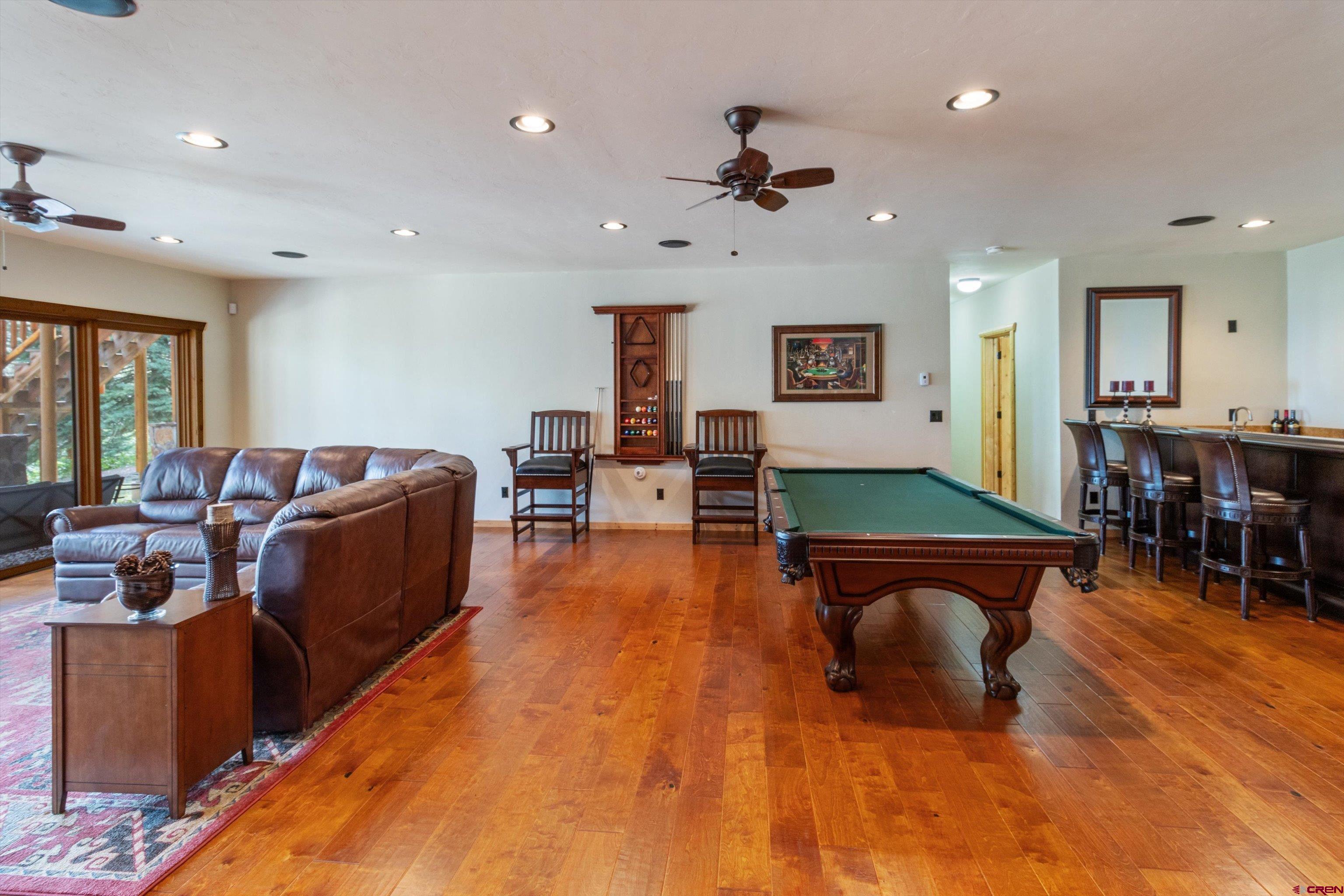 640 Clearview Road Durango, CO 81301 - Photo 29 of 40 a living room with furniture and a dining table with wooden floor