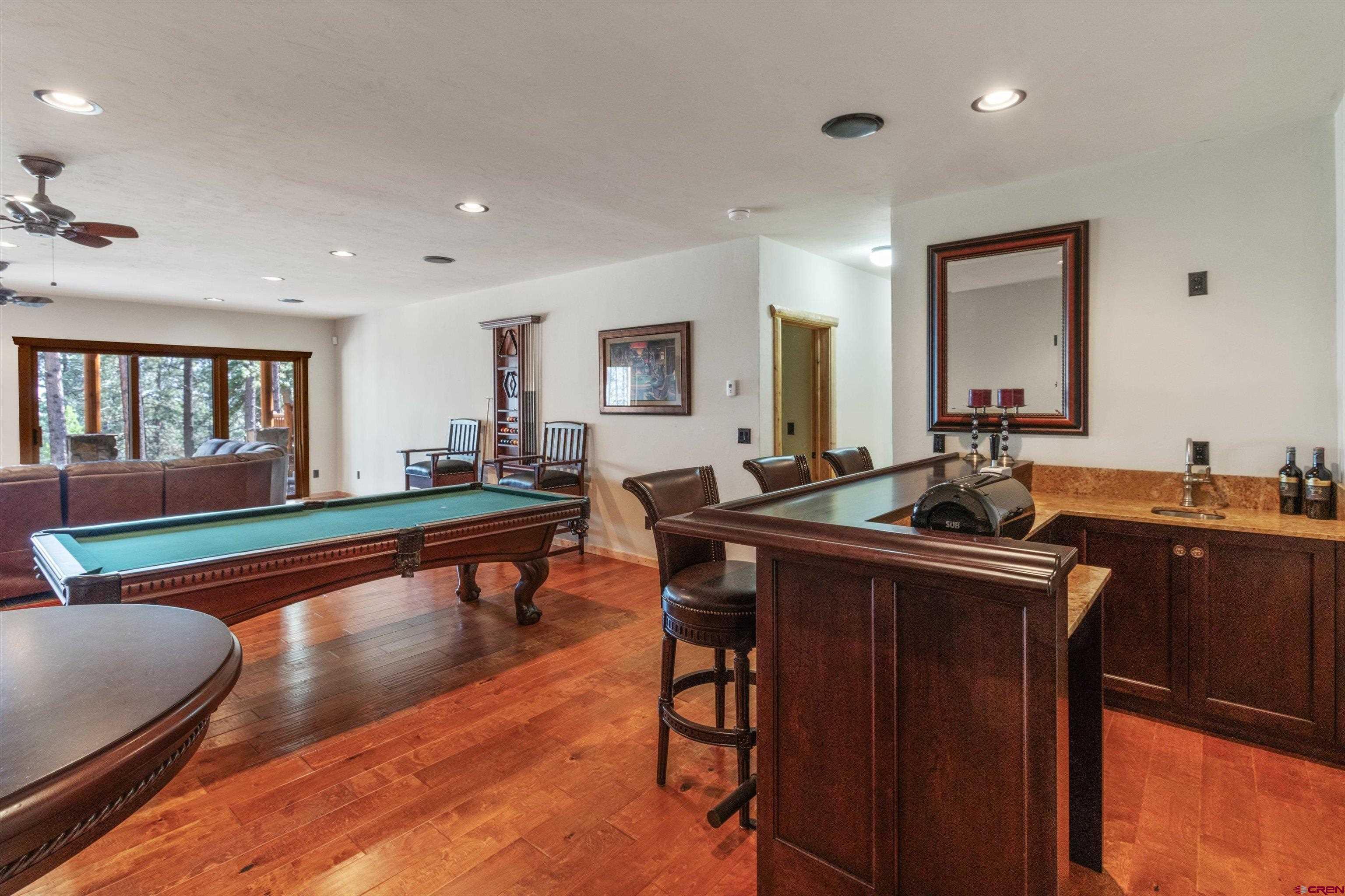 640 Clearview Road Durango, CO 81301 - Photo 30 of 40 a room with wooden floor table and chairs