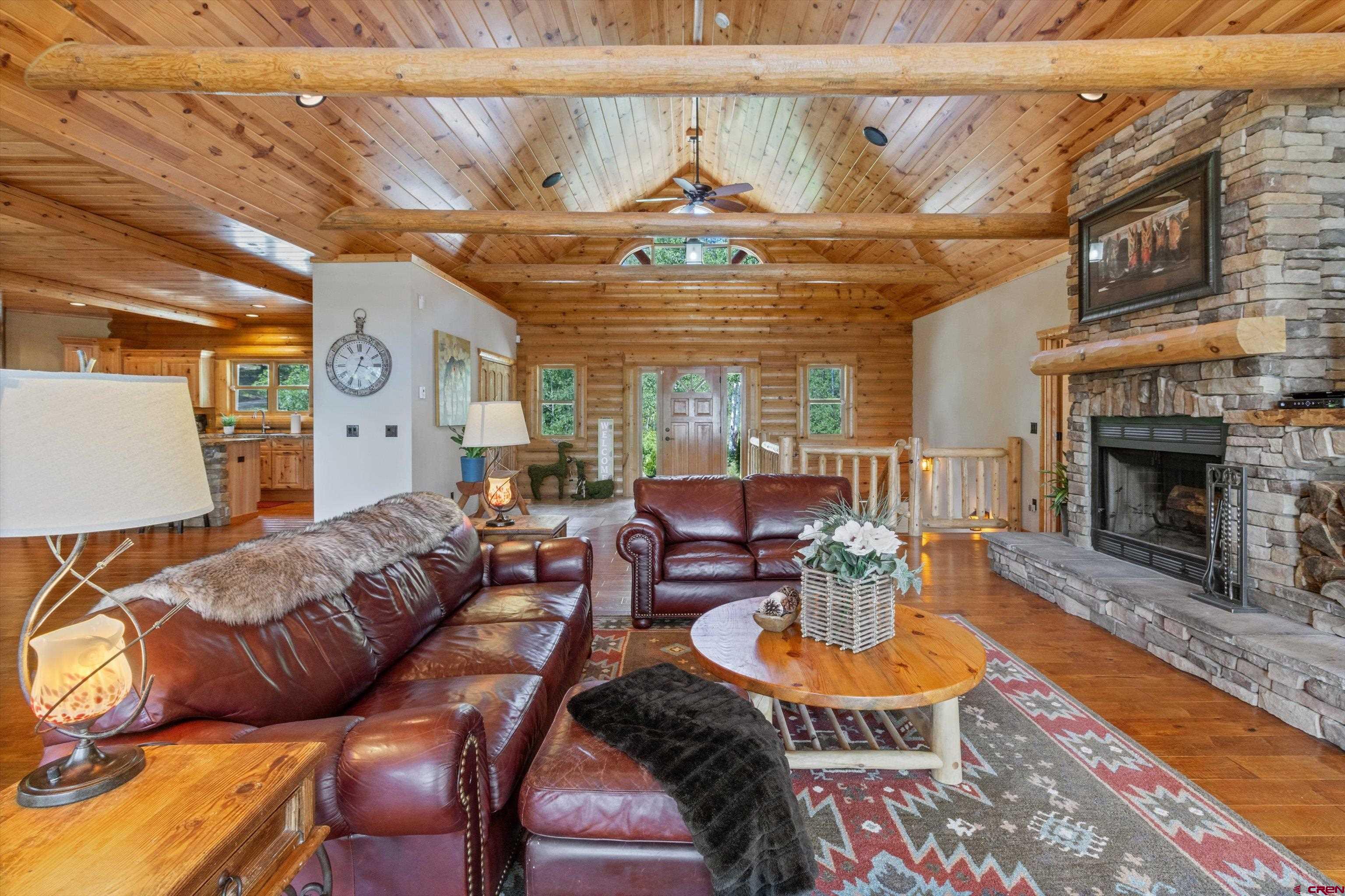 640 Clearview Road Durango, CO 81301 - Photo 8 of 40 a living room with furniture a fireplace and a table