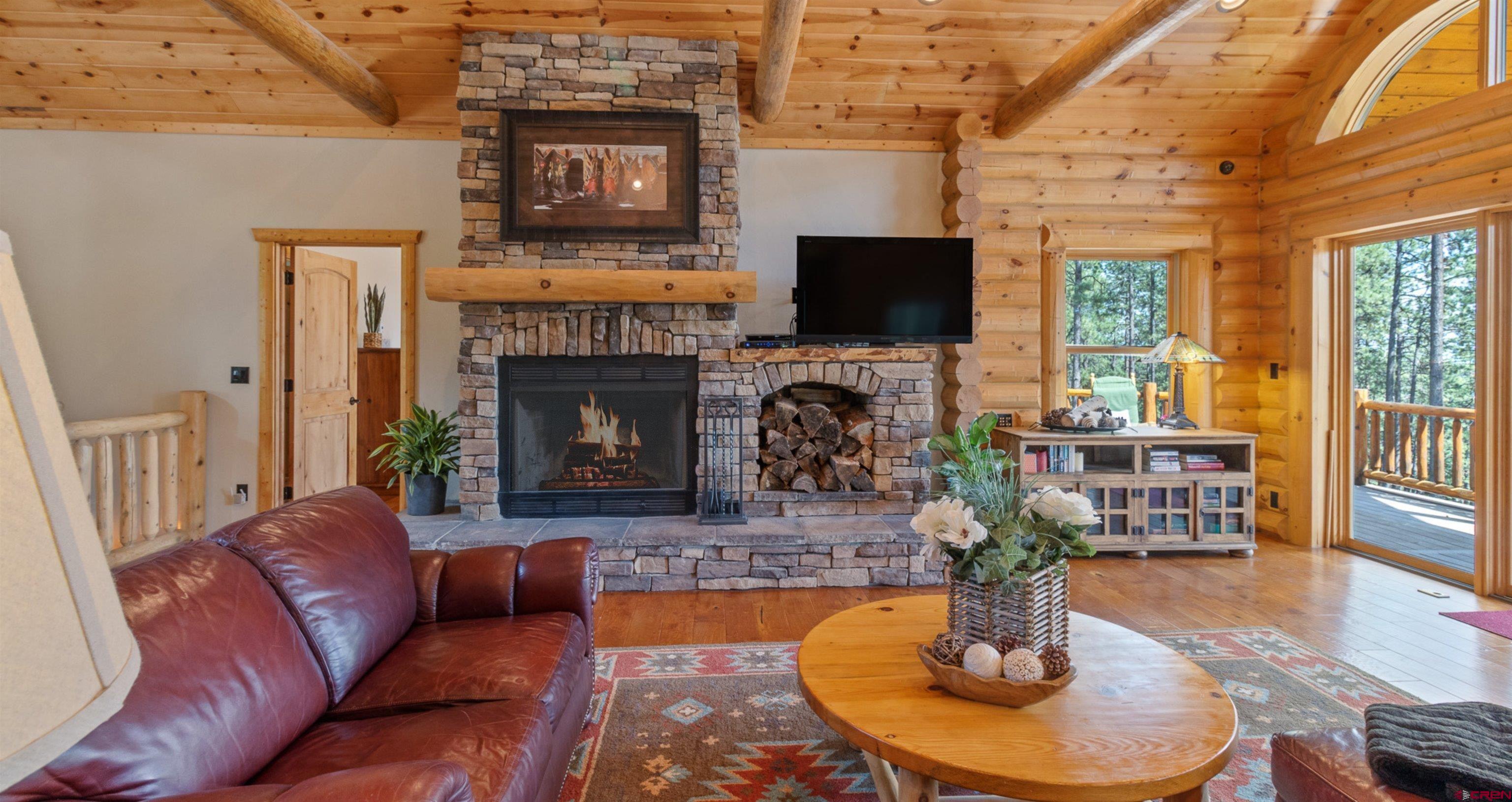 640 Clearview Road Durango, CO 81301 - Photo 10 of 40 a living room with furniture a flat screen tv and a fireplace