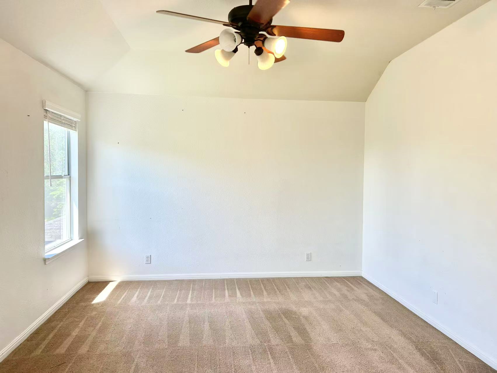 5608 Netleaf Road Austin, TX 78724 - Photo 18 of 26 Sun-filled room with vaulted ceilings and a classic ceiling fan, offering a comfortable atmosphere.