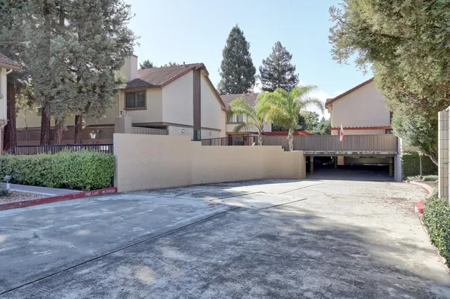 a view of a house with a backyard and trees