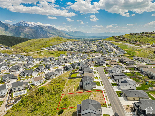14673 South Ravine Rock Way East, Unit 720 Draper, UT 84020 - Photo 10 of 15 Aerial view of residential area with property boundaries highlighted and a mountainous background