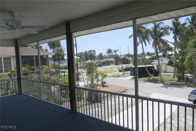 a view of a hallway with wooden floor and windows
