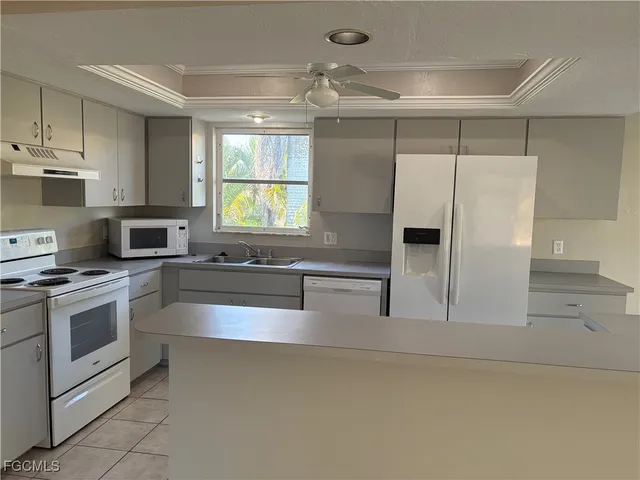 a kitchen with stainless steel appliances a refrigerator sink and stove