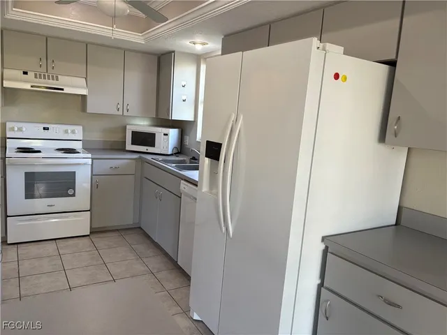 a white refrigerator freezer sitting inside of a kitchen