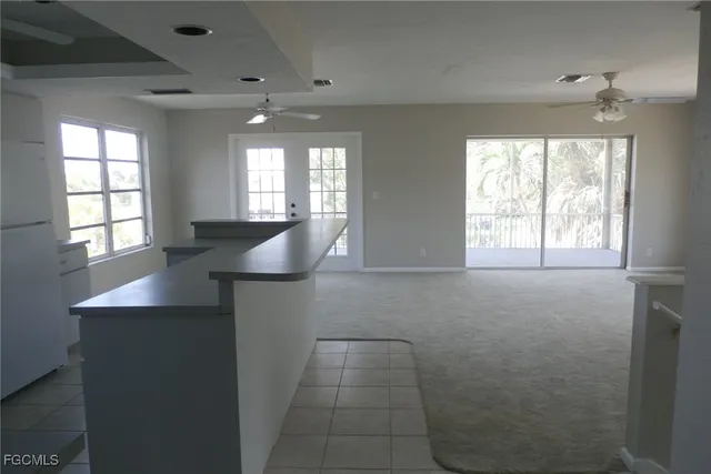 a kitchen with stainless steel appliances a sink window and cabinets