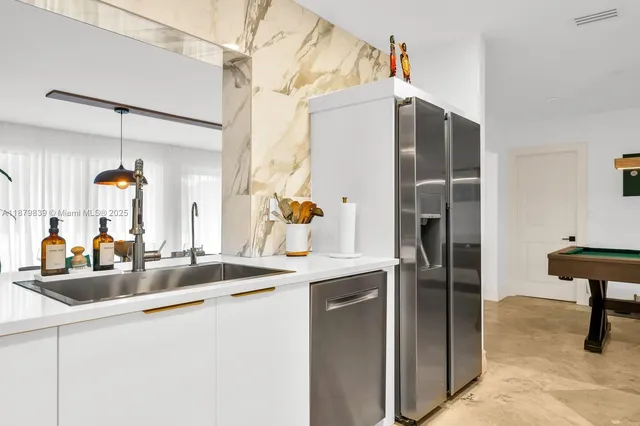 a kitchen with refrigerator and sink